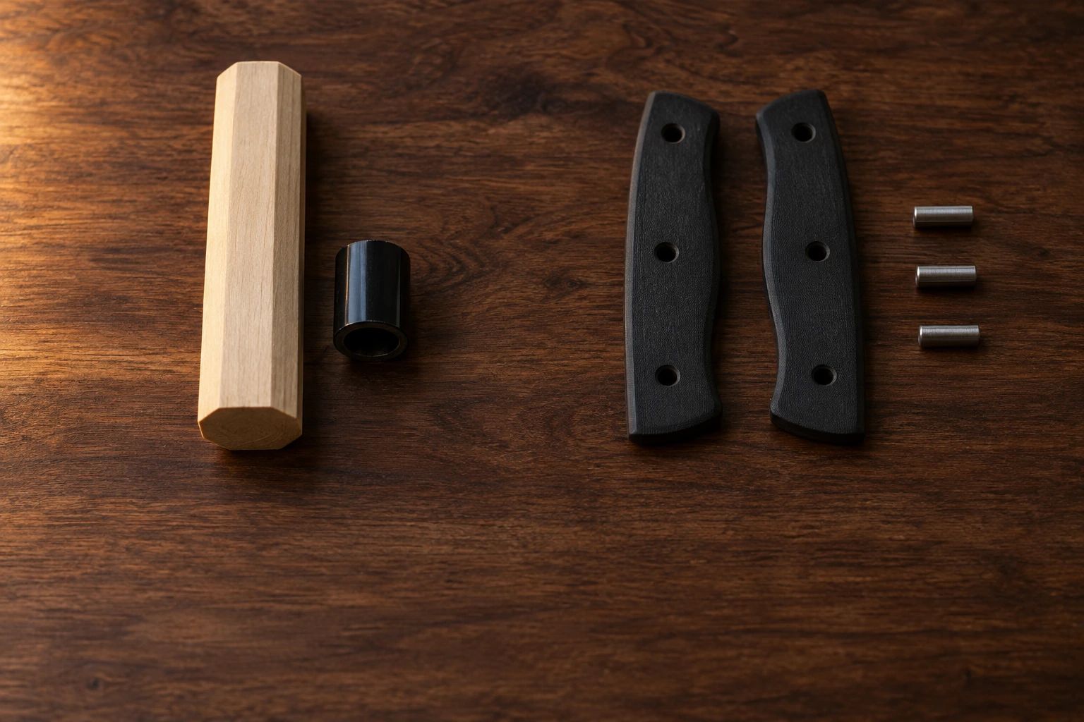 Unassembled handle parts on walnut: an octagonal wa handle and ferrule, and two Western scales with three pins